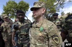 US General Donald C. Bolduc (C) walks on after been awarded with the officer decoration of the National Order of the Lion during the closing ceremony of the three-week joint military exercise between African, US and European troops.
