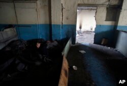 A migrant wakes up after spending the night inside a crumbling warehouse that has served as a makeshift shelter for hundreds of men trying to reach Western Europe in Belgrade, Serbia, Jan. 12, 2017. Migrants have been exposed to freezing temperatures and snow as extreme winter weather gripped Serbia and other parts of Europe in the last week.