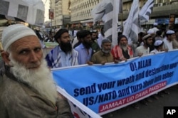 Supporters of a Pakistani religious party rally to condemn NATO's burning of Qurans in Afghanistan by NATO, in Karachi, Pakistan.