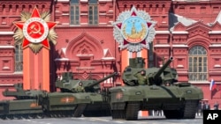 FILE - New Russian Armata tanks roll during the Victory Parade marking the 70th anniversary of the defeat of the Nazis in World War II, in Red Square in Moscow, May 9, 2015.