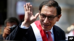 Peru's President Martin Vizcarra waves as he makes his way to the House of Pizarro, the presidential residence and workplace, in Lima, Peru, March 23, 2018. Vizcarra was sworn in, taking over from his predecessor, Pedro Pablo Kuczynski, who resigned over corruption allegations.