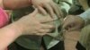 Visually-impaired theatergoers touch the skull, a prop in Everyman Theatre's production of "You Can’t Take It With You." 