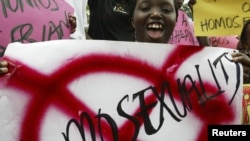 Members of religious groups campaigning against homosexuality hold placards during a rally in Kampala, Uganda, August 21, 2007.