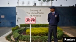 FILE - A private security guard stands outside the U.S. embassy in New Delhi, Dec. 18, 2013. 
