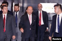 FILE - U.S. Commerce Secretary Wilbur Ross leaves a hotel ahead of trade talks with Chinese officials in Beijing, June 2, 2018.