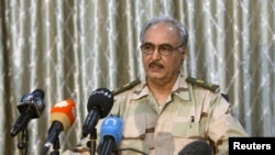 FILE - General Khalifa Haftar speaks during a news conference at a sports club in Abyar, a small town to the east of Benghazi.