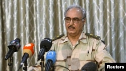 FILE - General Khalifa Haftar speaks during a news conference at a sports club in Abyar, a small town to the east of Benghazi.