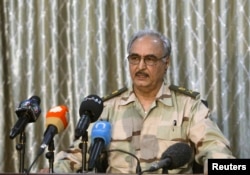FILE - General Khalifa Haftar speaks during a news conference at a sports club in Abyar, a small town to the east of Benghazi.