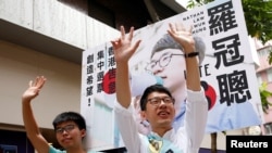 Nathan Law, (R), candidate from Demosisto and student activist Joshua Wong greet supporters on election day for the Legislative Council in Hong Kong, China, Sept. 4, 2016.