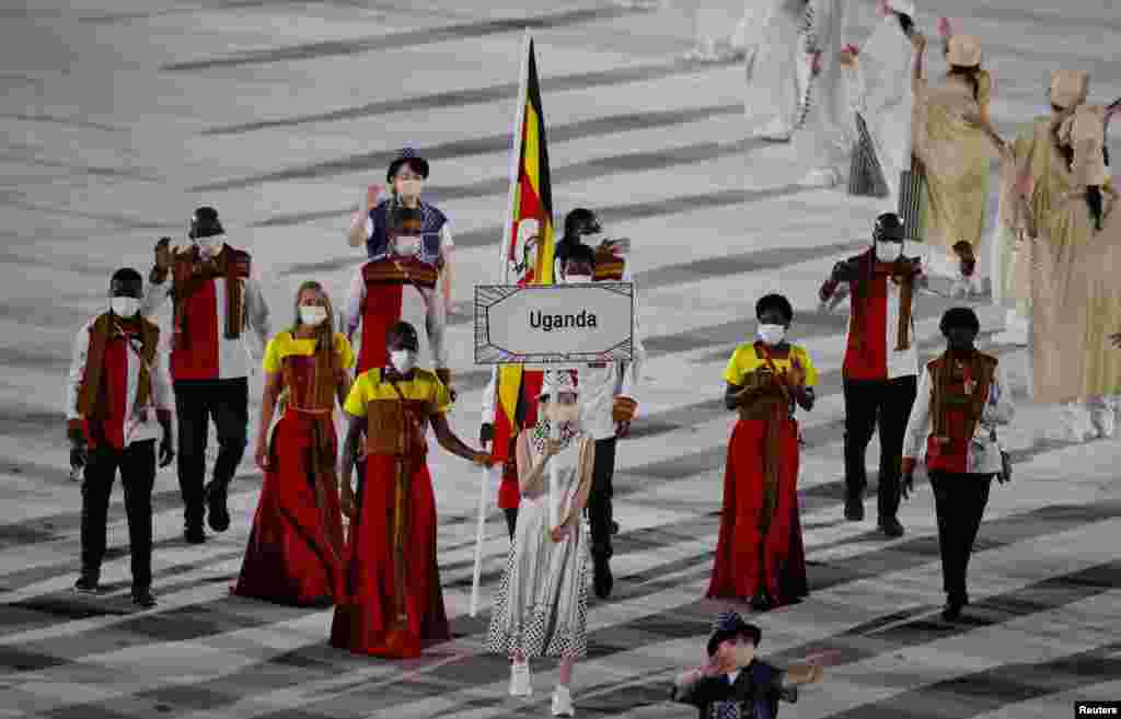 he Tokyo 2020 Olympics Opening Ceremony - Olympic Stadium, Tokyo, Japan - July 23, 2021. Flagbearers Musa Bwogi and Kirabo Namutebi of Uganda lead their contingent in the athletes parade during the opening ceremony REUTERS/Phil Noble