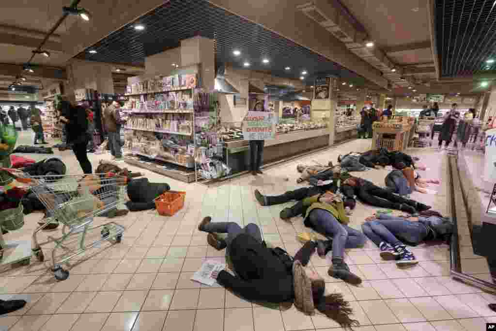 Ukrainians lay on a store's floor, acting as dead bodies in a flash mob action protesting against the buying of Russian goods in Kyiv.