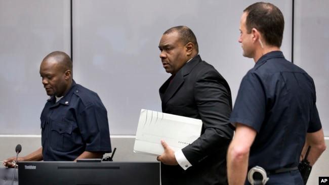 FILE - Jean-Pierre Bemba enters the courtroom of the International Criminal Court in The Hague, Netherlands, March 21, 2016. The court's judges handed him a guilty verdict.