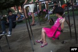 FILE - Children play in a park in downtown Yangon, March 13, 2017.