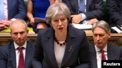 Britain's Prime Minister Theresa May addresses the House of Commons on her government's reaction to the poisoning of former Russian intelligence officer Sergei Skripal and his daughter Yulia in Salisbury, in London, March 14, 2018.