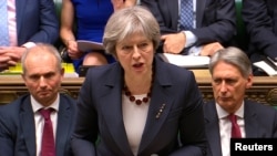 FILE - Britain's Prime Minister Theresa May addresses the House of Commons on her government's reaction to the poisoning of former Russian intelligence officer Sergei Skripal and his daughter Yulia in Salisbury, in London, March 14, 2018. 