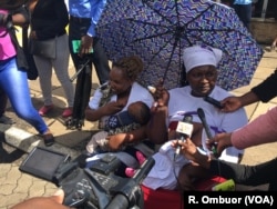 Mothers breastfeed there children outside parliament as they respond to questions from journalists in Nairobi, Kenya, May 15, 2018.