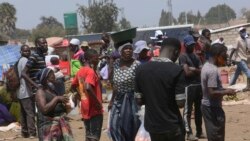 People are seen at a busy market in a poor community outside the capital Harare on November 15, 2021. (AP Photo/Tsvangirayi Mukwazhi)