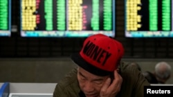 一名男子2019年5月6日在上海一家股市交易所查看股市行情。