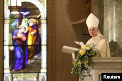 Archbishop Carlo Maria Vigano reads during the episcopal ordination of Auxiliary Bishops James Massa and Witold Mroziewski, in Brooklyn, New York, July 20, 2015.