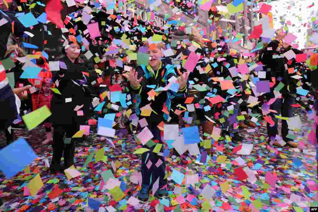 Times Square Alliance and Countdown Entertainment, co-organizers of Times Square New Years Eve, along with presenting sponsor, Planet Fitness test the air worthiness of the New Years Eve confetti from the Hard Rock Cafe marquee in New York, Dec. 29, 2016.