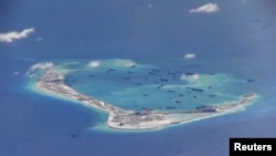 This picture from 2015 shows Chinese activity in the waters around Mischief Reef in the South China Sea. This still image is from video taken by a P-8A Poseidon surveillance aircraft provided by the U.S. Navy.