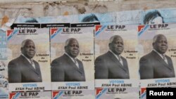 FILE - Election posters for opposition candidate Ayah Paul Abine of the People Action Party are pasted on a wall in the capital Yaounde, Cameroon, Oct. 7, 2011. 