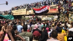 Protesters rally at a demonstration near the military headquarters, April 9, 2019, in the capital Khartoum, Sudan. 