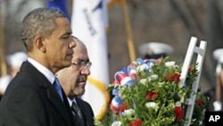 President Barack Obama and Iraq's PM Nouri al-Maliki lay a wreath at the Tomb of the Unknowns, Monday, at Arlington National Cemetery in Arlington, Virginia, Dec. 12, 2011