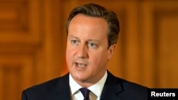 Britain's Prime Minister David Cameron makes a statement to the media following the killing of Scottish aid worker David Haines, at Number 10 Downing Street in London, Sept. 14, 2014.