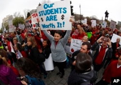 Teachers and their supporters from Douglas and Jefferson counties in Colorado cheer during a teacher rally in Denver, April 26, 2018.