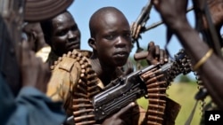 South Sudan government soldiers in the town of Koch, Unity state, South Sudan. A U.N. report describing sweeping crimes like children and the disabled being burned alive and fighters being allowed to rape women as payment shows South Sudan is facing "one of the most horrendous human rights situations in the world," the U.N. human rights chief said Friday, March 11, 2016. (AP Photo/Jason Patinkin, File)