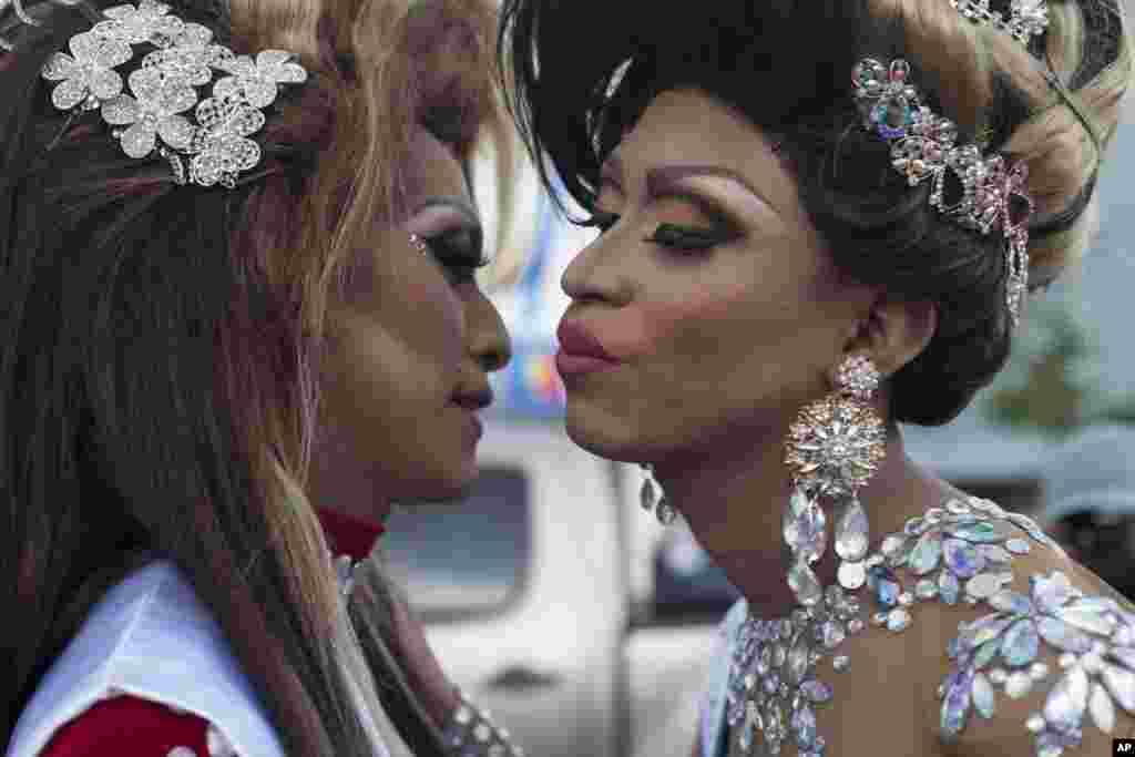 Revelers kisses before taking part in the annual gay pride parade in Guatemala City's historical center, June 24, 2017.