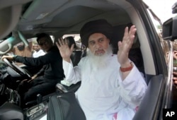 FILE - Khadim Hussain Rizvi, head of Tehreek-e-Labbaik Pakistan, a radical religious party, speaks to journalists during a rally for the upcoming general elections, in Karachi, Pakistan, July 1, 2018.