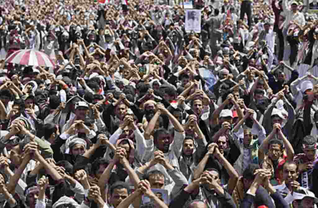 Anti-government protesters gesture during a demonstration demanding the resignation of Yemeni President Ali Abdullah Saleh, in Sana'a, Friday, June 10, 2011