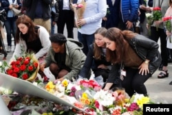 People leave tributes for Labour Member of Parliament Jo Cox in Parliament Square, London, Britain, June 17, 2016.