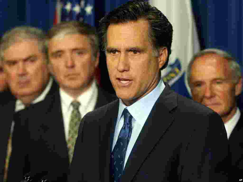 Mass. Gov. Mitt Romney, front right, proposed legislation to hike the fines for companies that spill oil or other toxic substances into Massachusetts waters, May 20, 2003. 