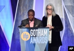 Director Yance Ford, left, and producer Joslyn Barnes accept the best documentary award for "Strong Island" at the 27th annual Independent Film Project's Gotham Awards at Cipriani Wall Street, Nov. 27, 2017, in New York.