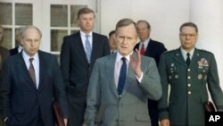 FILE - In this Feb. 11, 1991, file photo, President George H.W. Bush talks to reporters in the Rose Garden of the White House after meeting with top military advisors to discuss the Persian Gulf War.