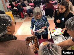 Furloughed government workers, contractors and their families attended a free community dinner donated from families and community organizations during the partial U.S. government shutdown at Montgomery Blair High School in Silver Spring, Maryland, Jan. 12, 2018.