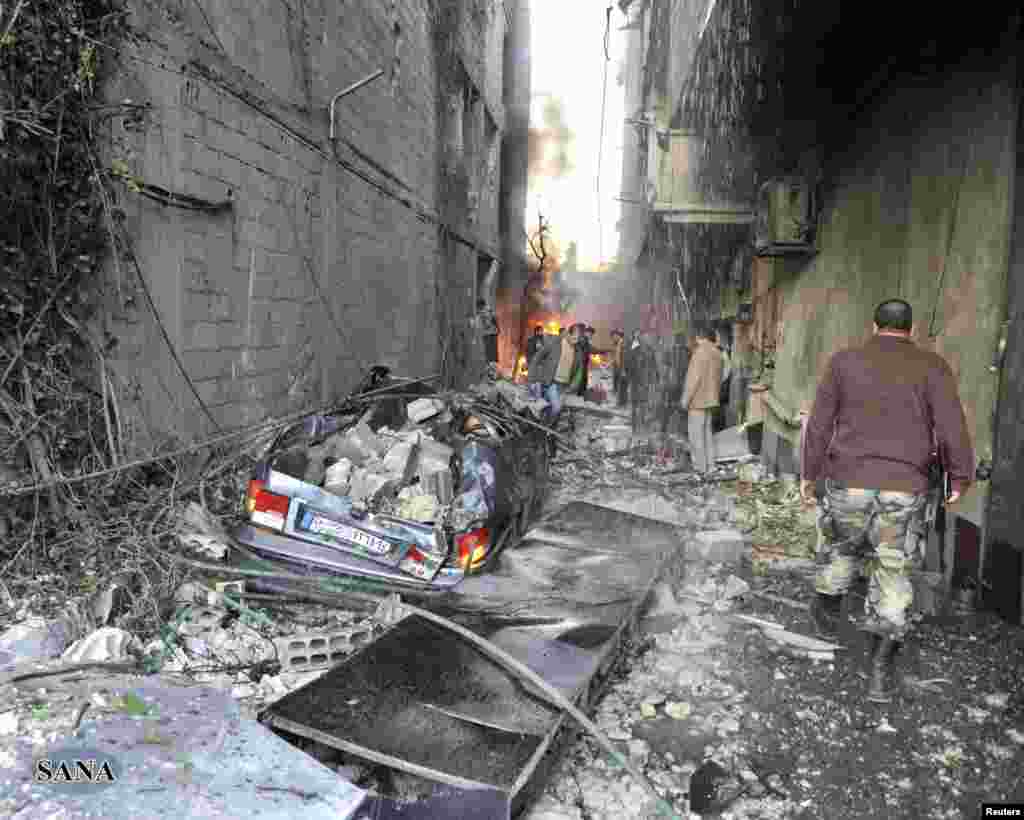 A crowd gathers at the site of a blast in Jaramana district, near Damascus, in this handout photograph released by Syria's national news agency SANA, November 28, 2012.