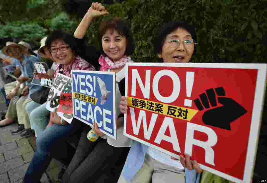 People hold placards during an anti-government rally near Prime Minister Shinzo Abe's official residence in Tokyo, Japan. On the 70th anniversary of the end of World War II Abe expressed deep remorse over the war.