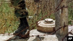 A Lebanese soldier steps over a landmine. (file)
