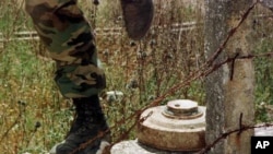 A Lebanese soldier steps over a landmine. (file)