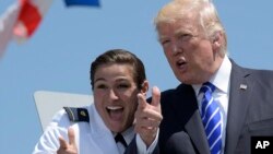 President Donald Trump poses for a photo with U.S. Coast Guard graduate Erin Leigh Reynolds during commencement exercises at the U.S. Coast Guard Academy in New London, Conn., Wednesday, May 17, 2017. (AP Photo/Susan Walsh)