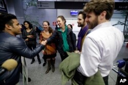 Former U.S. Army interpreter Qismat Amin, left, is greeted by supporters after arriving from Afghanistan at San Francisco International Airport, Feb. 8, 2017, in San Francisco. Amin waited nearly four years for his special immigrant visa.