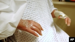 FILE - The hands of a burn victim are pictured after she received skin grafts. 
