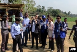 FILE - Yanghee Lee (C), the U.N.'s Special Rapporteur on the situation of human rights in Myanmar, visits the Balu Khali Rohingya camp in Cox's Bazar, Feb. 21, 2017.