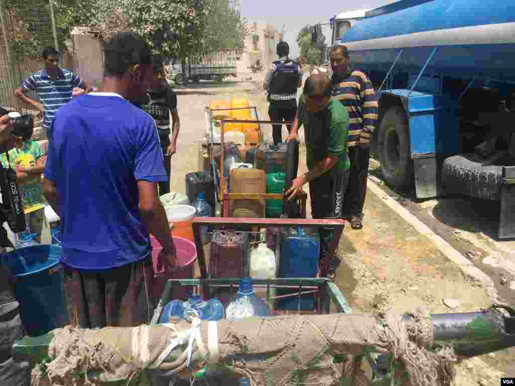 Distribution of water among residents in Mansur neighborhood, right side of Mosul.