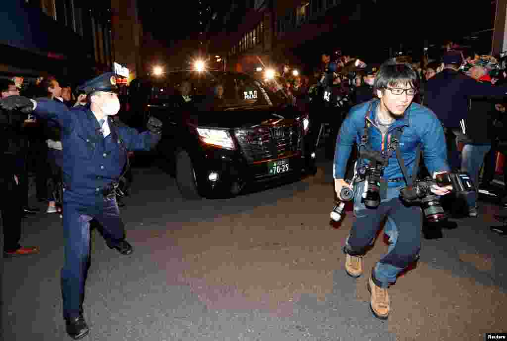 A car carrying former Nissan Motor Chairman Carlos Ghosn is surrounded by journalists as it leaves Ghosn&#39;s lawyer&#39;s office, in Tokyo, Japan.