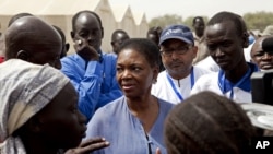United Nations Under-Secretary-General for Humanitarian Affairs and Emergency Relief Coordinator for South Sudan, Valerie Amos, engages with local government officials and humanitarian aid workers in the village of Walgak, South Sudan on Thursday, Feb. 2,